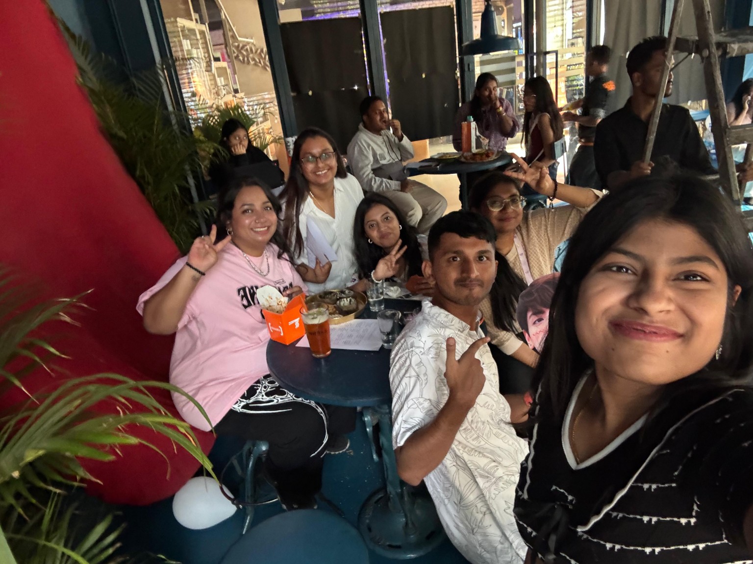 Group selfie of attendees around a table during a screening night
